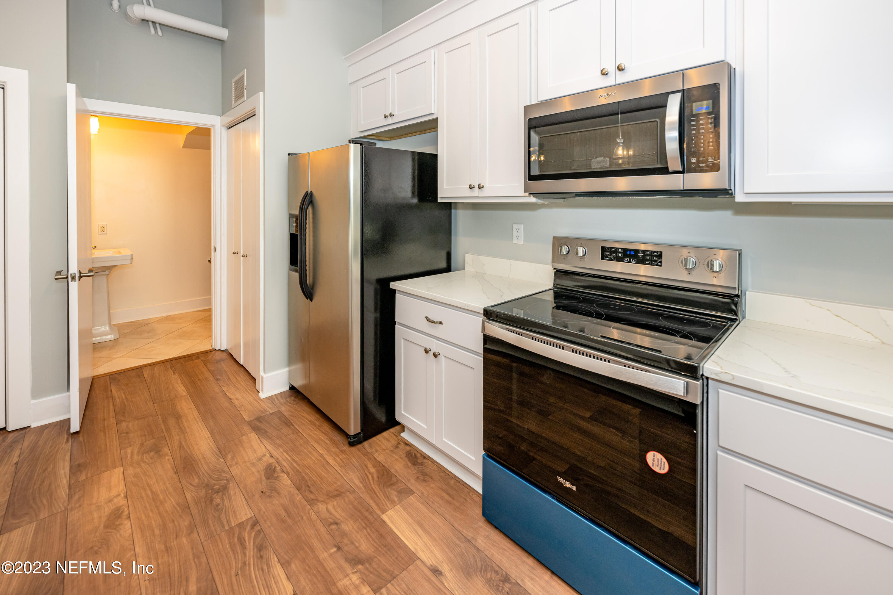 1661 Riverside Avenue, Unit 119 Jacksonville, FL 32204 - Photo 15 of 45 a kitchen with a stove microwave and refrigerator