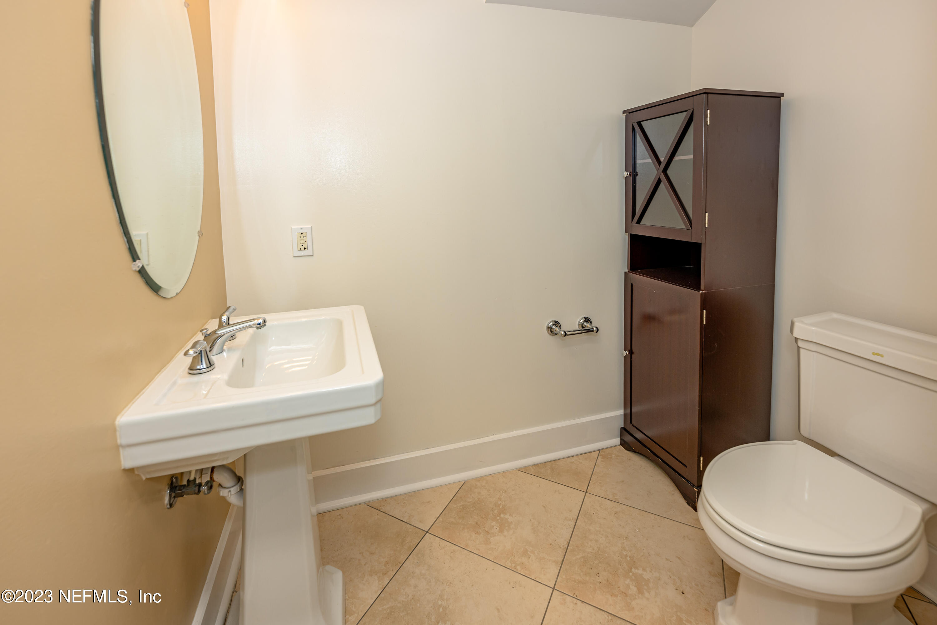 1661 Riverside Avenue, Unit 119 Jacksonville, FL 32204 - Photo 18 of 45 a bathroom with a sink toilet and a mirror
