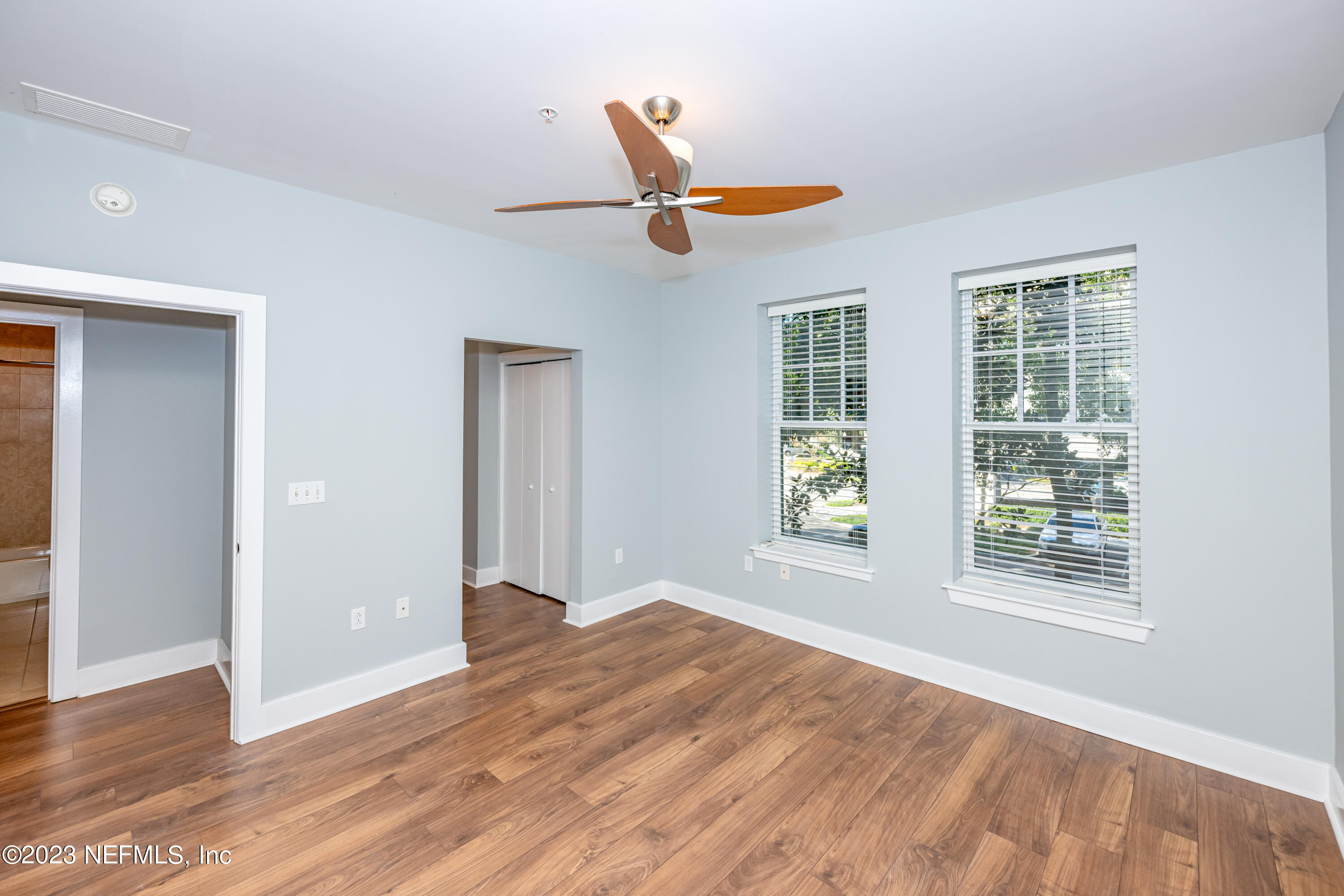 1661 Riverside Avenue, Unit 119 Jacksonville, FL 32204 - Photo 21 of 45 a view of an empty room with wooden floor and a window