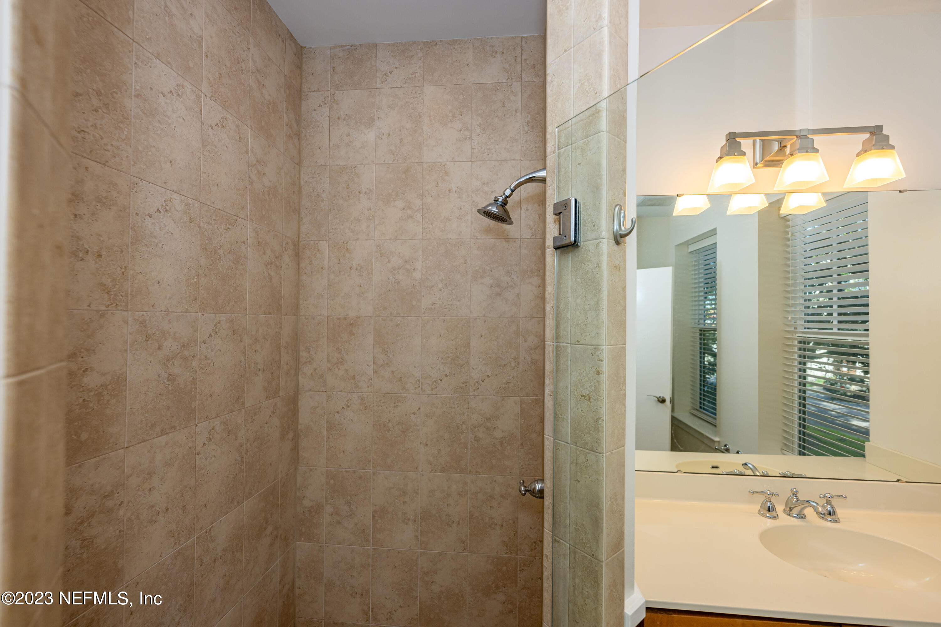 1661 Riverside Avenue, Unit 119 Jacksonville, FL 32204 - Photo 26 of 45 a bathroom with a sink and a mirror