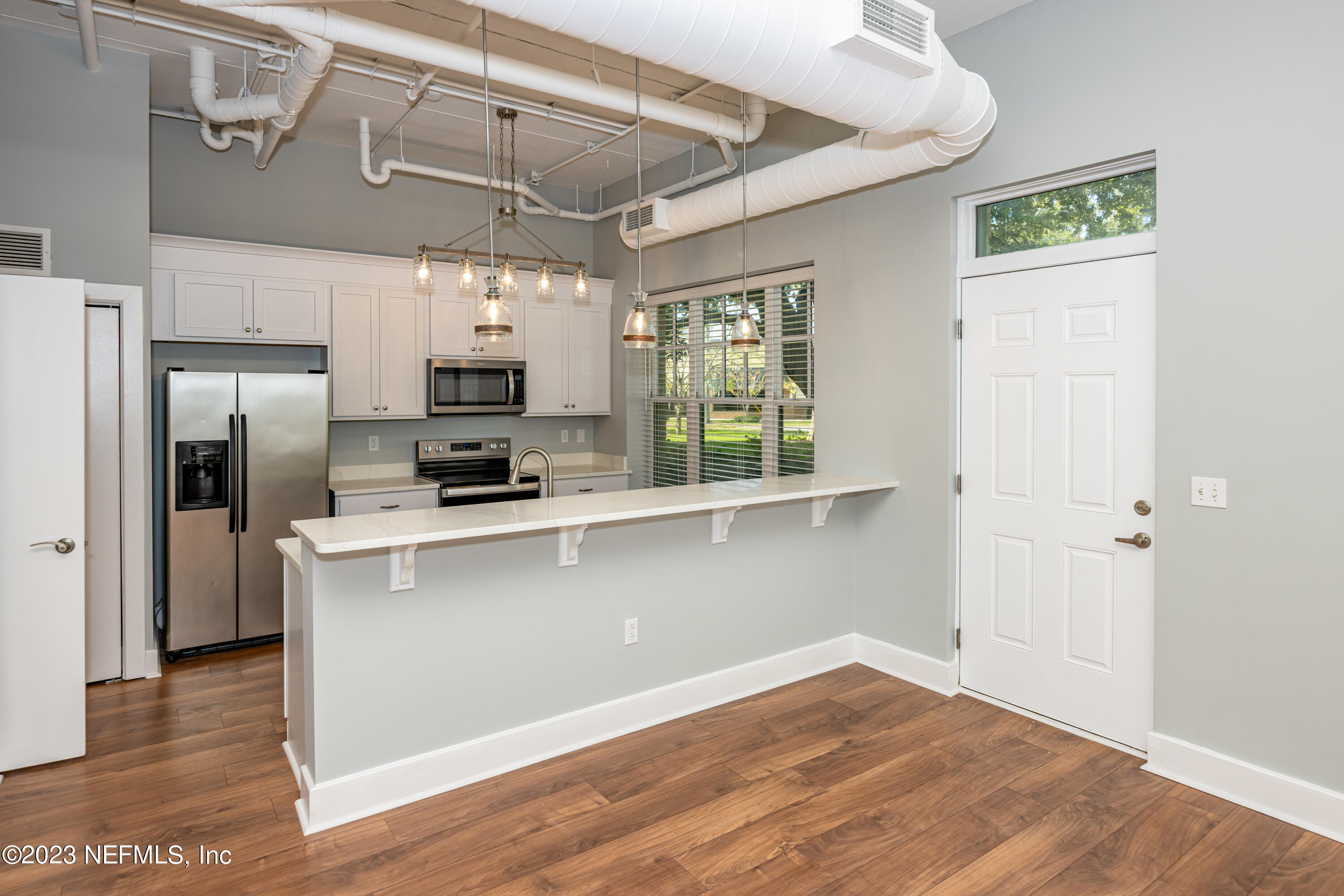 1661 Riverside Avenue, Unit 119 Jacksonville, FL 32204 - Photo 7 of 45 a kitchen with stainless steel appliances granite countertop a refrigerator and a stove top oven
