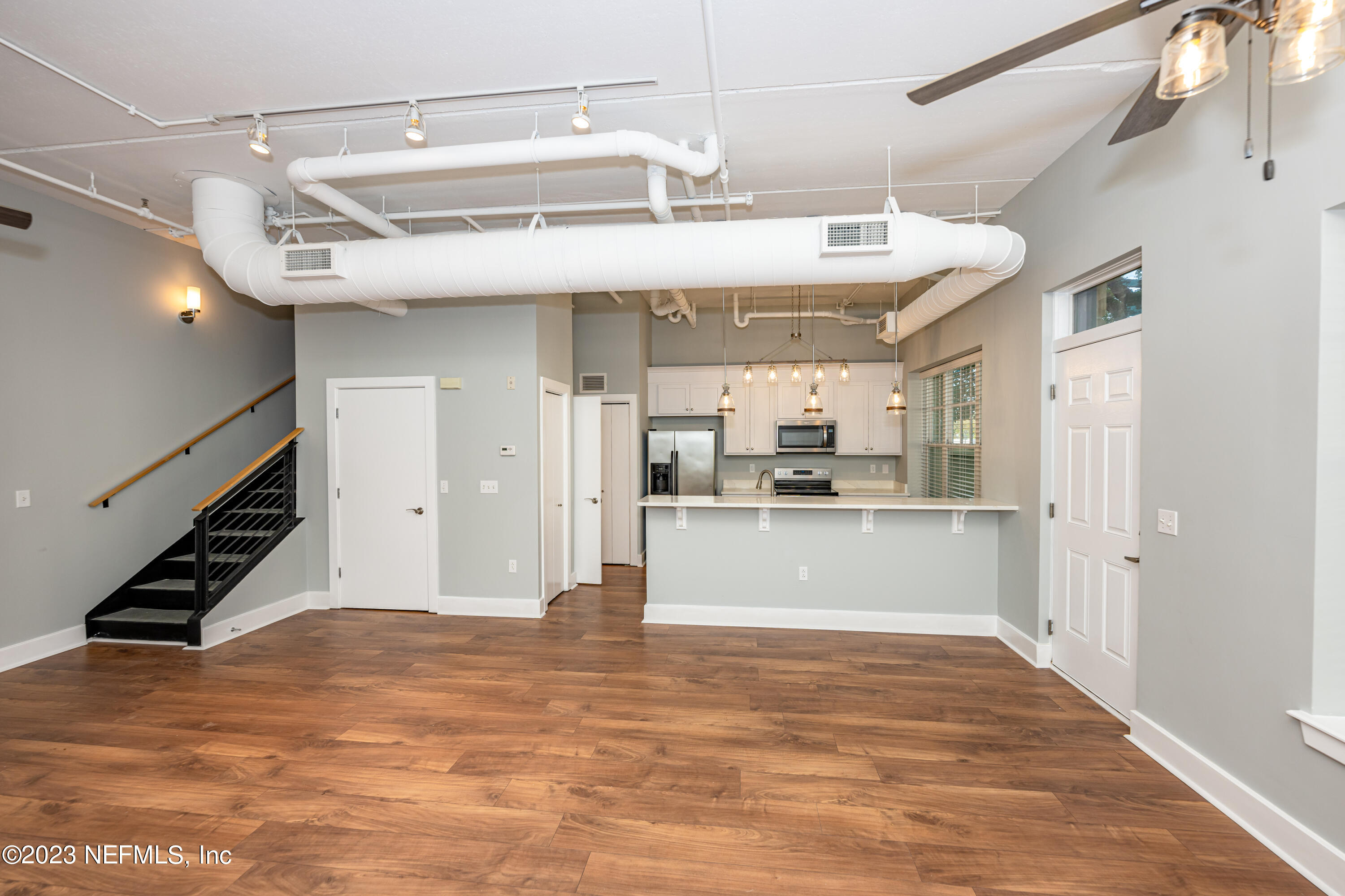 1661 Riverside Avenue, Unit 119 Jacksonville, FL 32204 - Photo 9 of 45 a view of a room with wooden floor and staircase