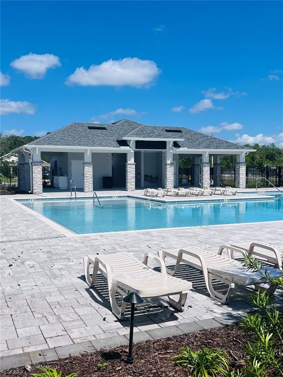 7521 Bent Tree Loop St. Cloud, FL 34773 - Photo 3 of 3 a view of a house with pool and chairs