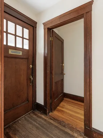 a view of front door with wooden floor