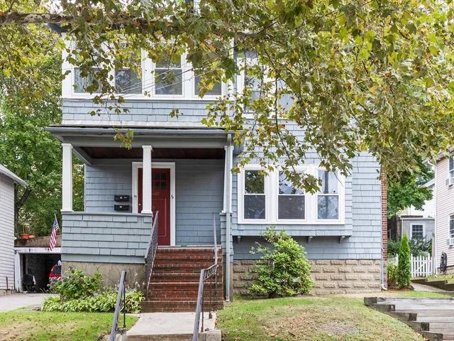 a house that has a tree in front of the house