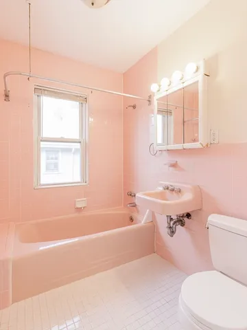 a bathroom with a sink a toilet a mirror and a bathtub