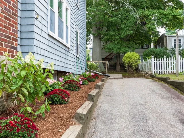 a view of a house with a yard and table and chair