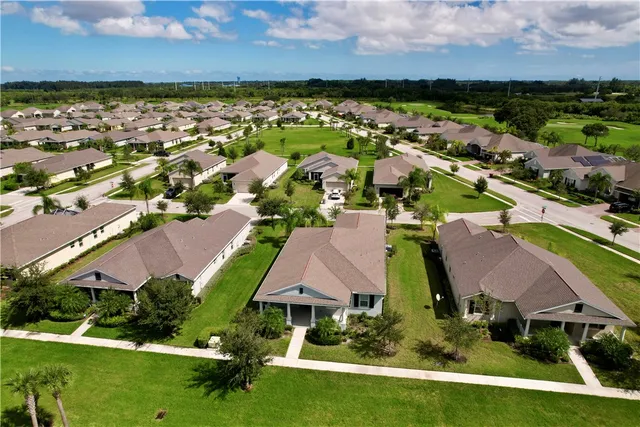 an aerial view of house with yard swimming pool and outdoor seating