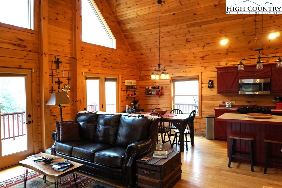 182 Buckland Road Grassy Creek, NC 28631 - Photo 11 of 38 a living room with furniture and a flat screen tv