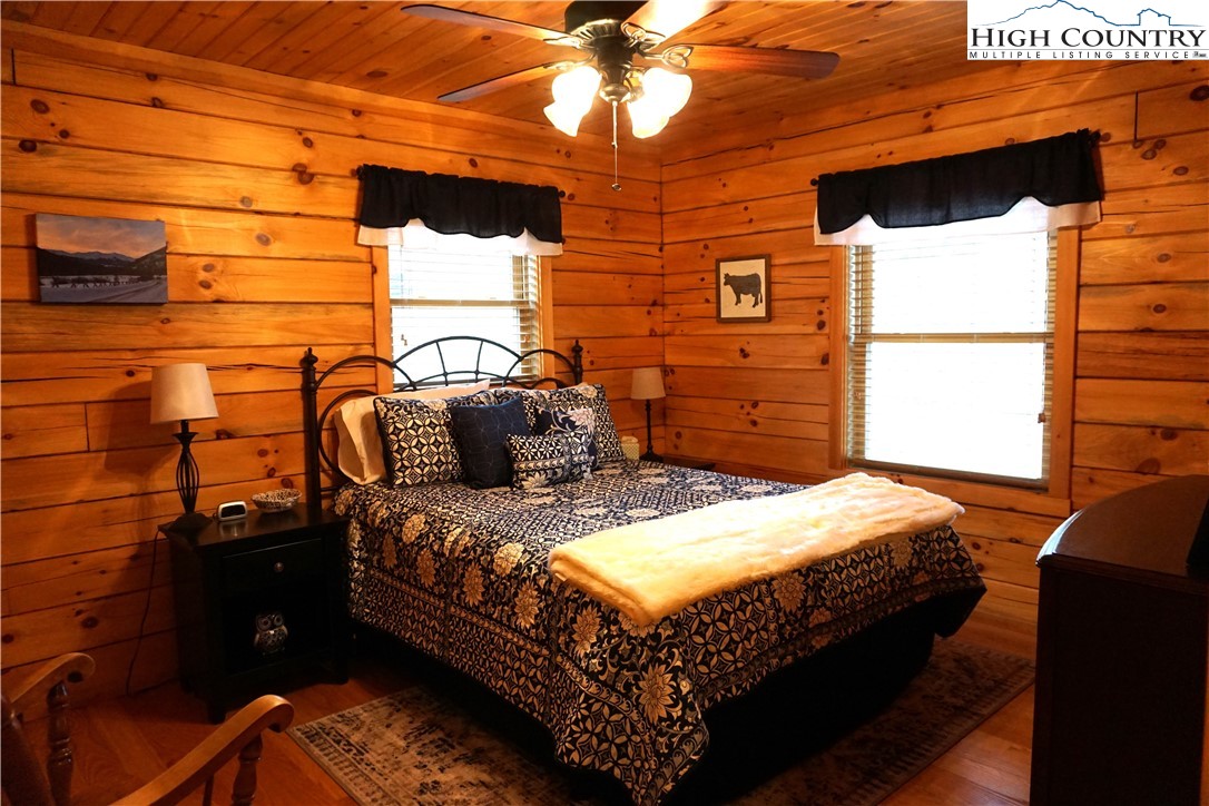 182 Buckland Road Grassy Creek, NC 28631 - Photo 14 of 38 a bed sitting in a bedroom next to a window
