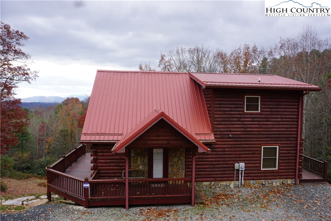 182 Buckland Road Grassy Creek, NC 28631 - Photo 2 of 38 a front view of a house with garden