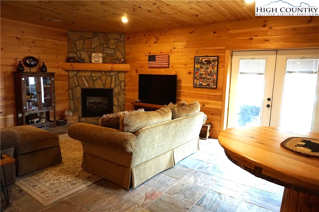 182 Buckland Road Grassy Creek, NC 28631 - Photo 23 of 38 a living room with furniture and a fireplace
