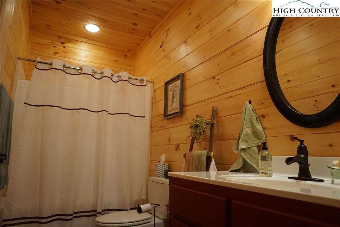 182 Buckland Road Grassy Creek, NC 28631 - Photo 27 of 38 a bathroom with a sink and a mirror