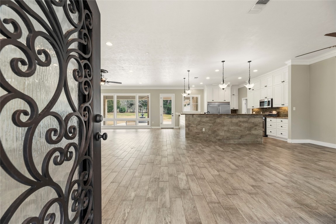 2051 Hillview Road Bellville, TX 77418 - Photo 13 of 47 Beautiful entry with tile flooring, crown molding and neutral interior.