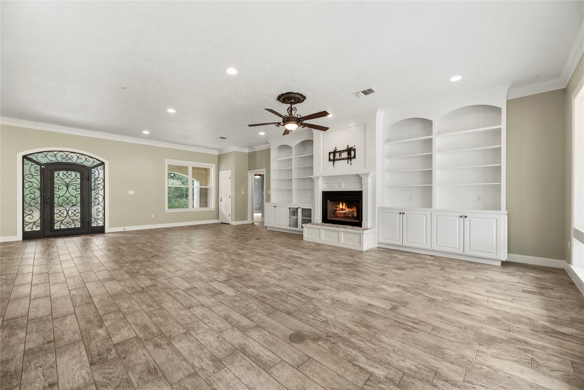 2051 Hillview Road Bellville, TX 77418 - Photo 14 of 47 The family room offers tile flooring, crown molding, cozy fireplace and custom built-ins.