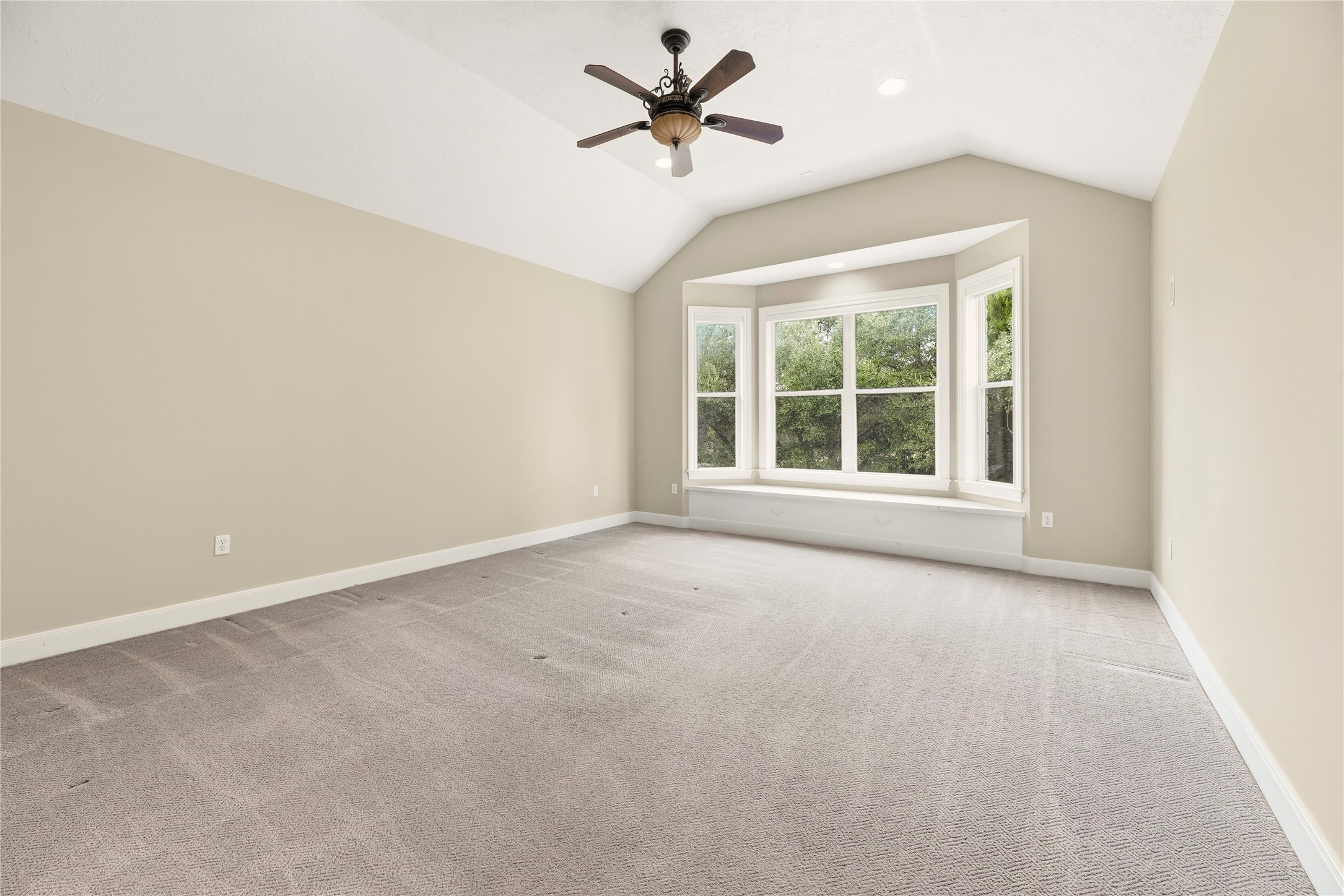 2051 Hillview Road Bellville, TX 77418 - Photo 21 of 47 Primary retreat boasts plush carpet, high ceiling, ceiling fan, sitting cabinet for storage and an en-suite bathroom. It is also wheelchair accessible!