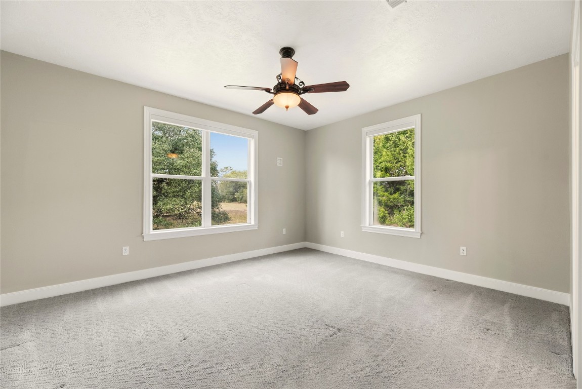 2051 Hillview Road Bellville, TX 77418 - Photo 25 of 47 Both secondary bedrooms are spacious and wheelchair accessible with plush carpet, ceiling fans and large closets. They are connected by a Jack n' Jill bathroom.