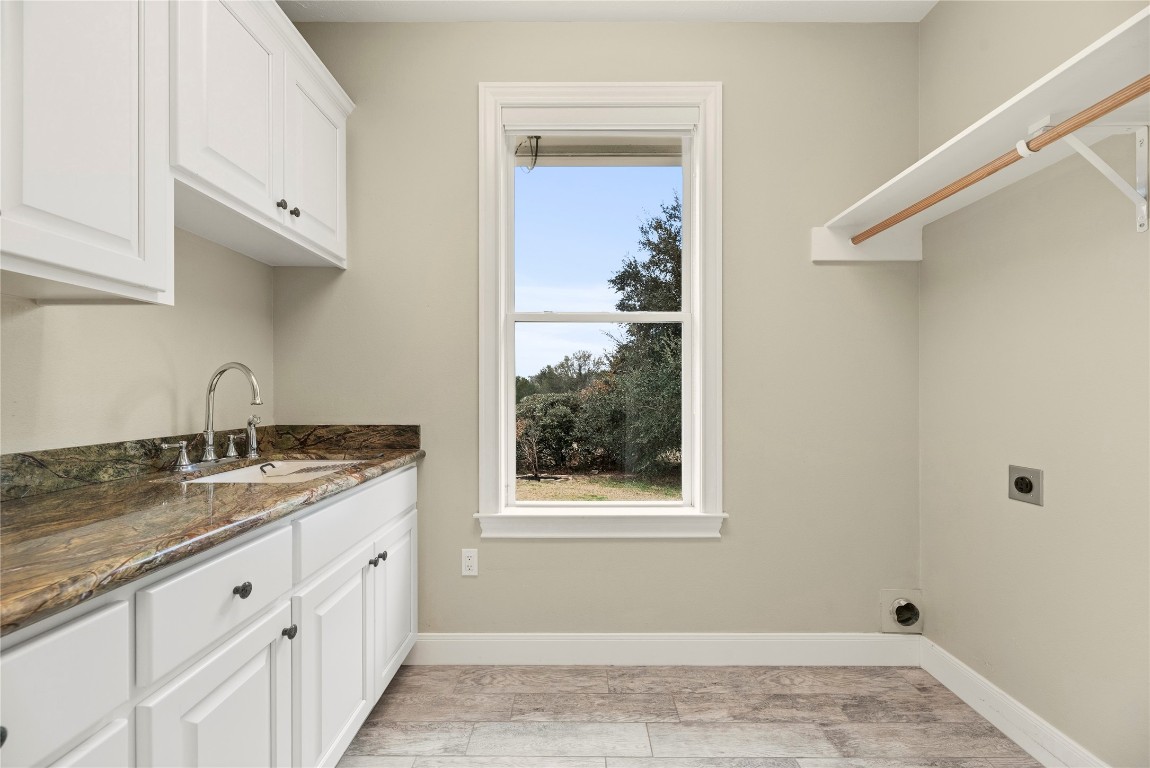 2051 Hillview Road Bellville, TX 77418 - Photo 29 of 47 Laundry room has a convenient sink and additional storage.
