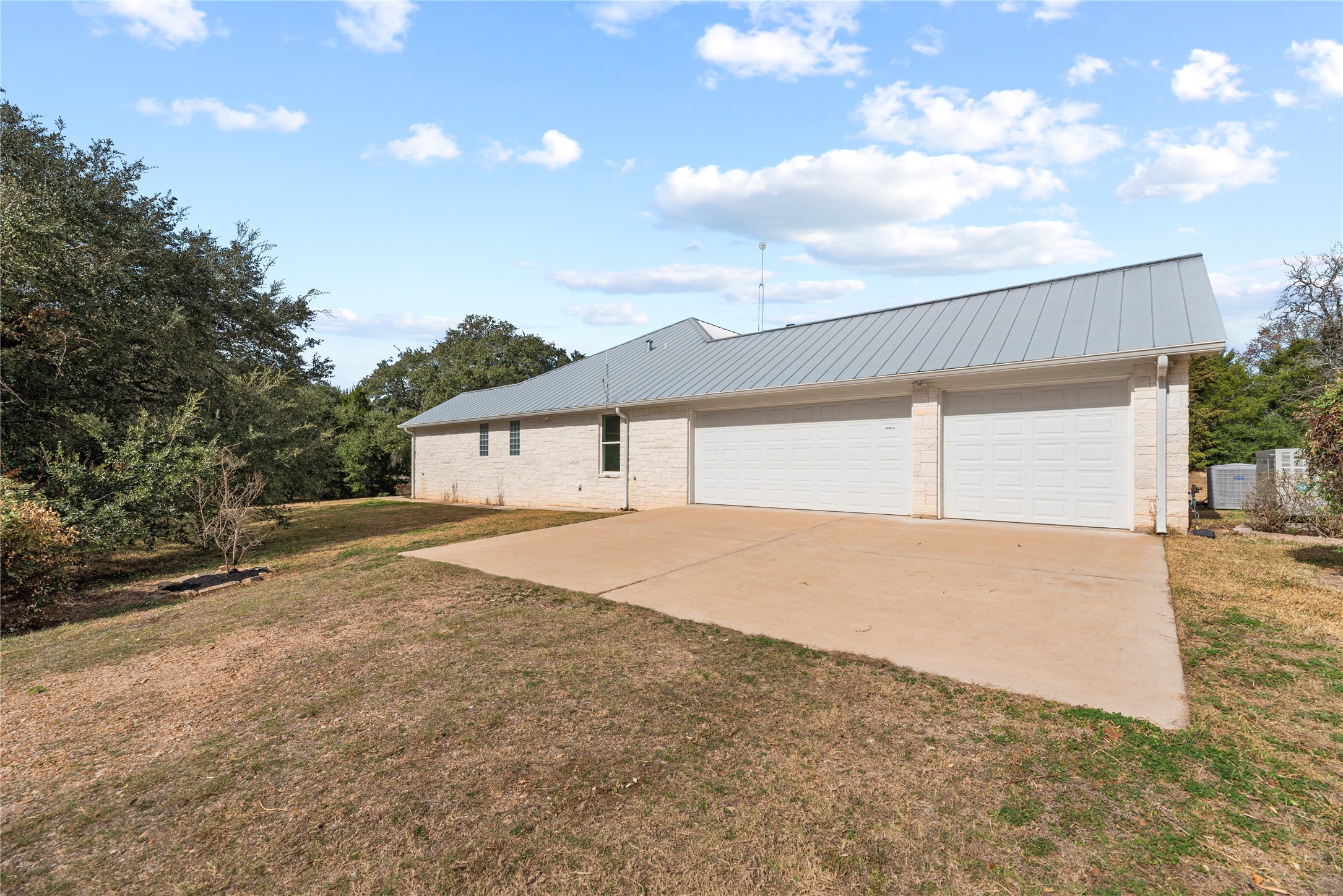 2051 Hillview Road Bellville, TX 77418 - Photo 9 of 47 Attached 3-car garage with large work bench and shelves, and a concrete driveway.