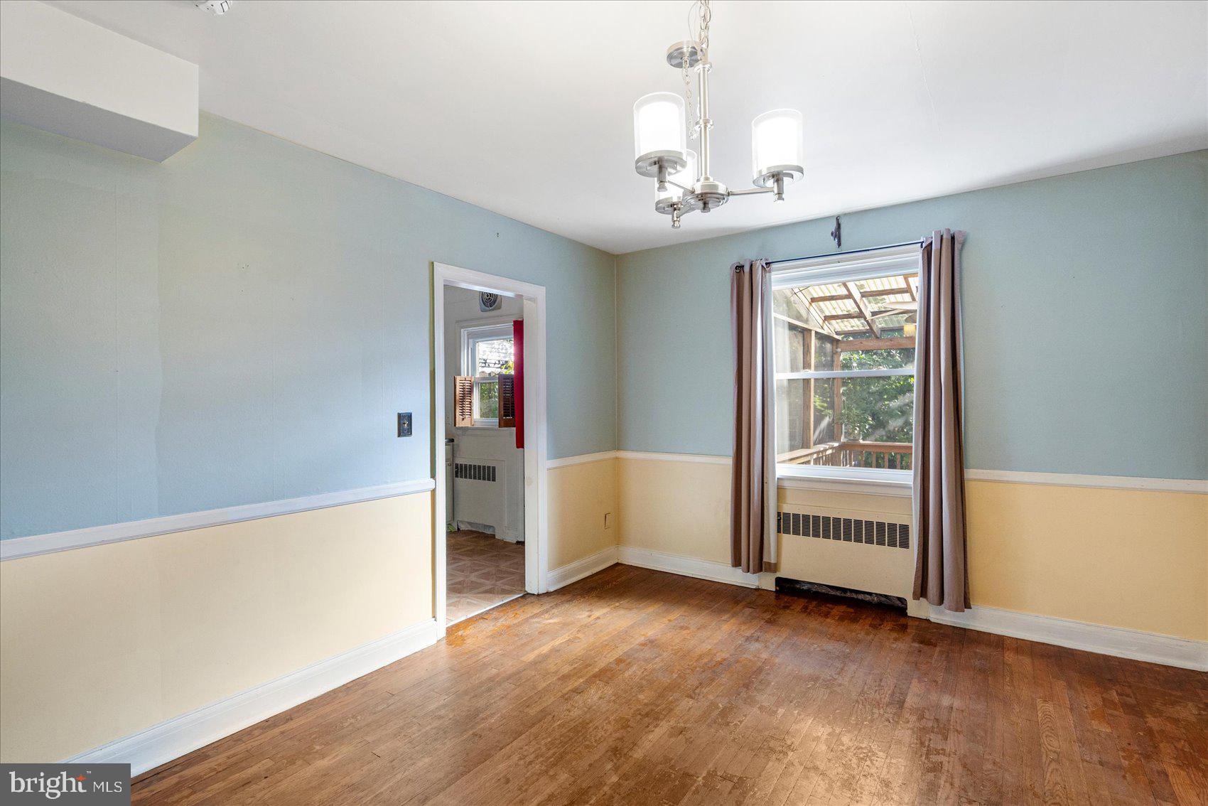 3915 Rexmere Road Baltimore, MD 21218 - Photo 11 of 41 wooden floor in an empty room with a window