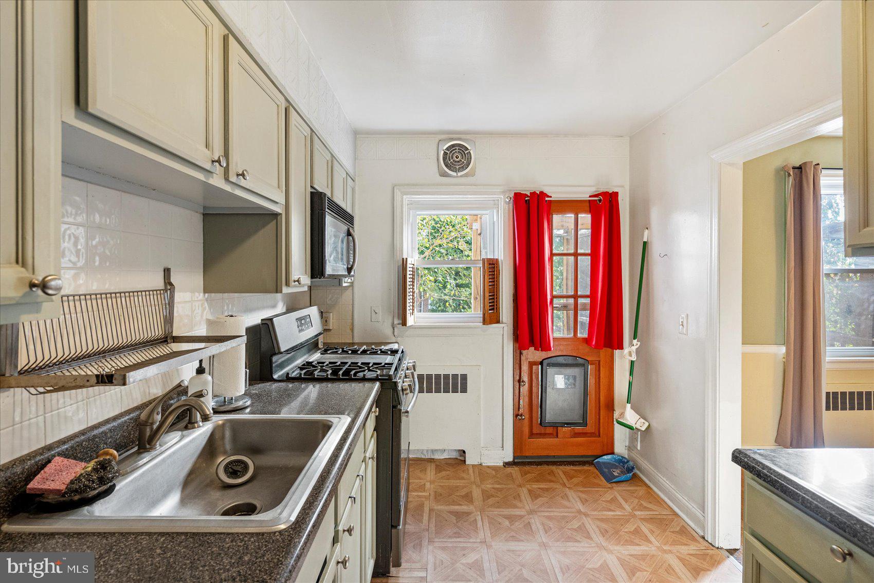 3915 Rexmere Road Baltimore, MD 21218 - Photo 15 of 41 a kitchen that has a stove and a sink