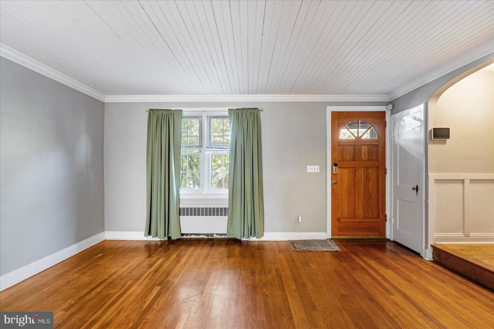 3915 Rexmere Road Baltimore, MD 21218 - Photo 3 of 41 an empty room with wooden floor and windows