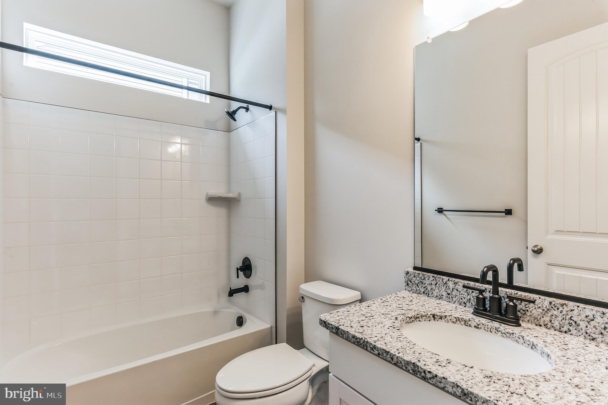 21 Golden Raintree Court Middletown, DE 19709 - Photo 13 of 28 a bathroom with a granite countertop sink toilet and shower