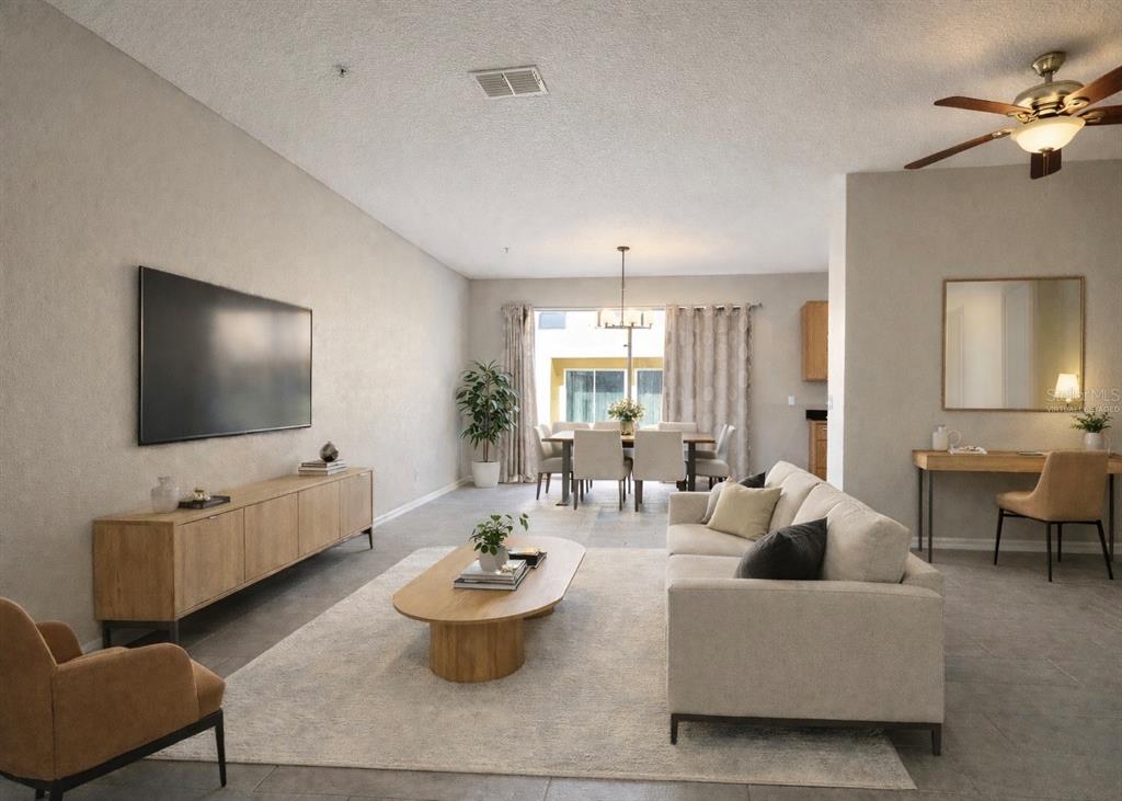 709 Fortanini Circle Ocoee, FL 34761 - Photo 2 of 22 a living room with furniture and a flat screen tv