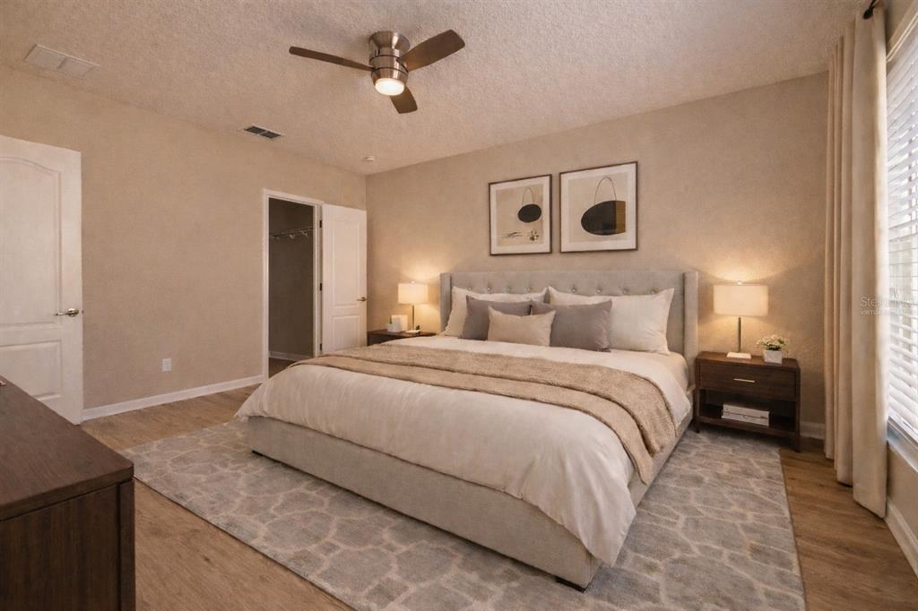 709 Fortanini Circle Ocoee, FL 34761 - Photo 4 of 22 a bedroom with a bed and a chandelier
