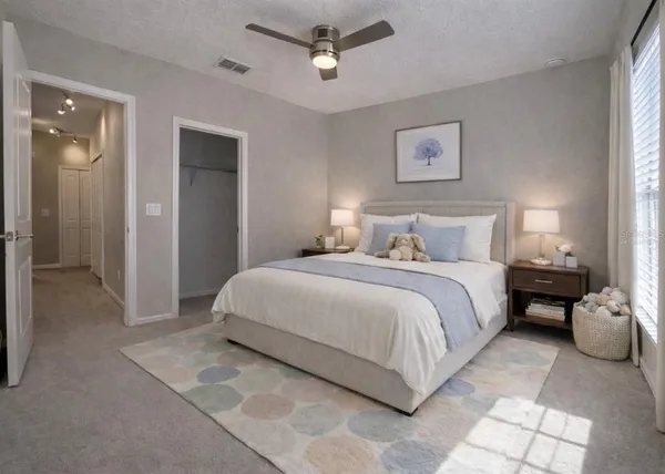 a bedroom with a bed and painting on the wall