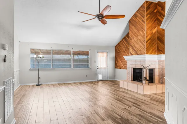 wooden floor in an empty room with a fireplace