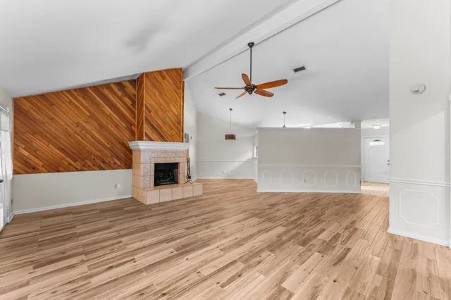 a view of a livingroom with a fireplace and a ceiling fan