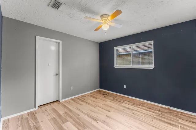 a view of a room with a wooden floor and a window
