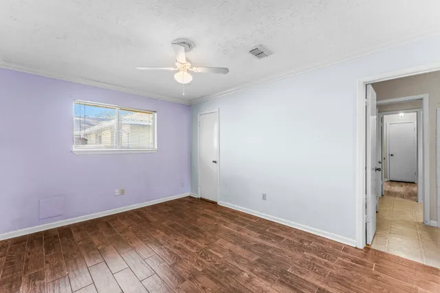 wooden floor in an empty room with a window