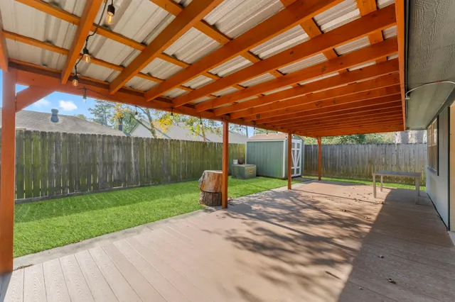 a backyard view of a house with trampoline