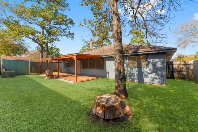 a backyard of a house with table and chairs
