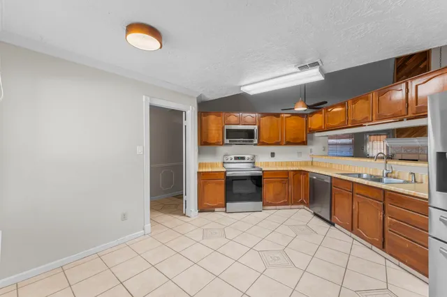 a large white kitchen with a sink and cabinets