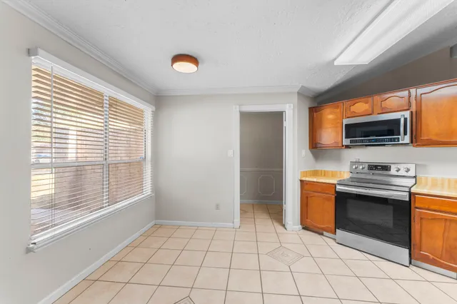 a kitchen with stainless steel appliances a stove a sink and a microwave