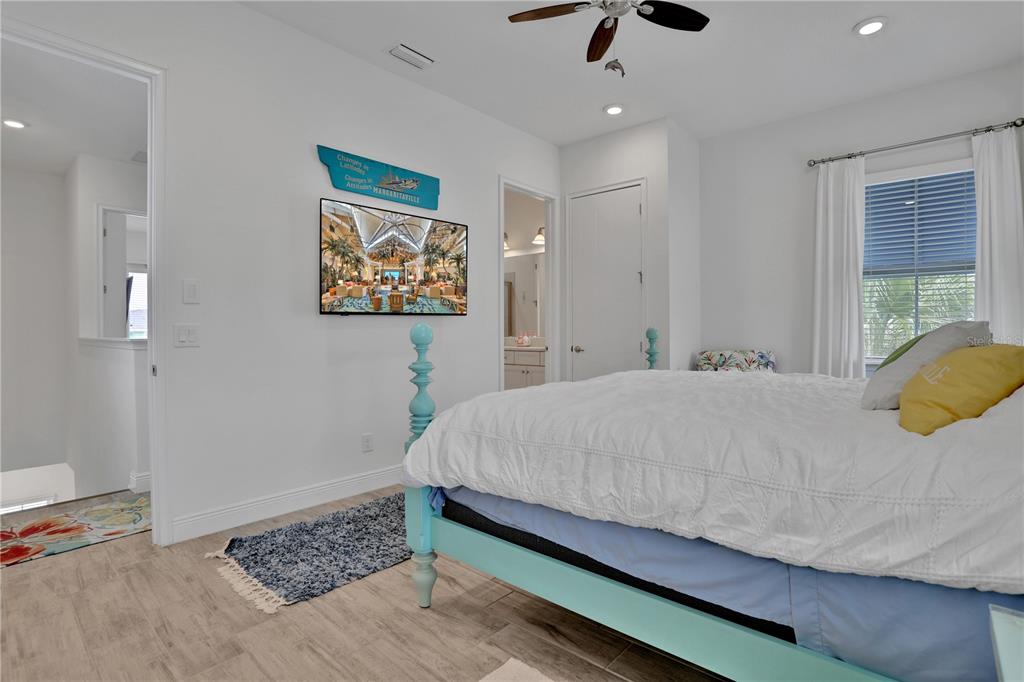 3083 Key Lime Loop Kissimmee, FL 34747 - Photo 24 of 82 a bedroom with a bed and a painting on the wall