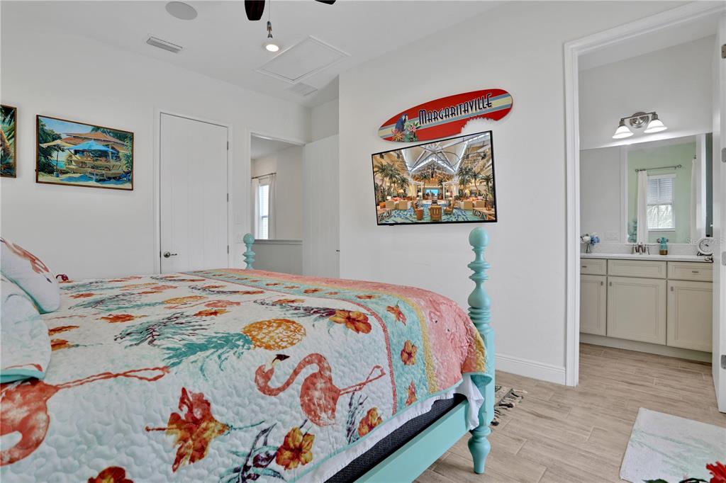 3083 Key Lime Loop Kissimmee, FL 34747 - Photo 29 of 82 a bedroom with a bed and a chandelier