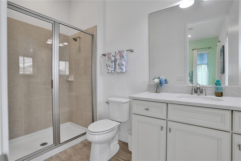 3083 Key Lime Loop Kissimmee, FL 34747 - Photo 30 of 82 a bathroom with a shower sink vanity mirror and toilet