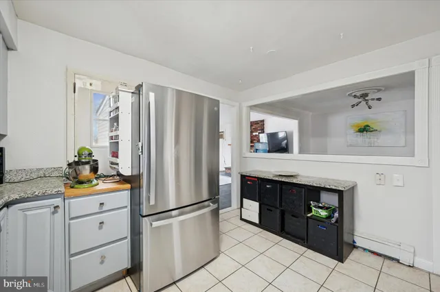 a kitchen with stainless steel appliances a refrigerator and a stove top oven