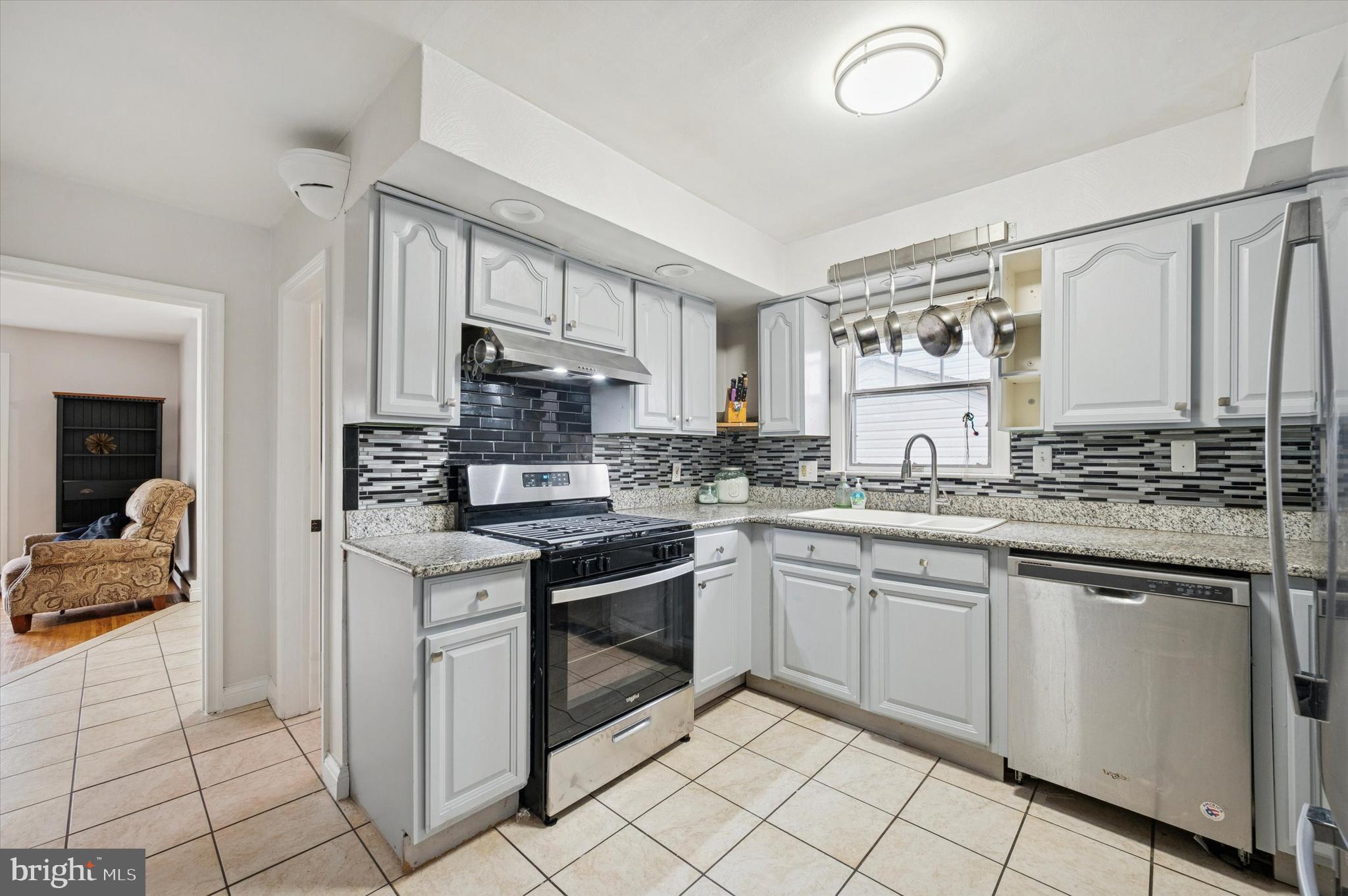 42 Colonial Road Havertown, PA 19083 - Photo 9 of 27 a kitchen with stainless steel appliances granite countertop a sink and cabinets