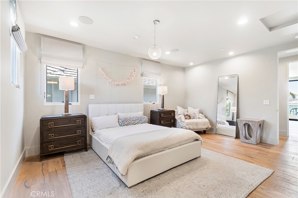 660 Kings Road Newport Beach, CA 92663 - Photo 28 of 41 a spacious bedroom with a bed a couch and dresser