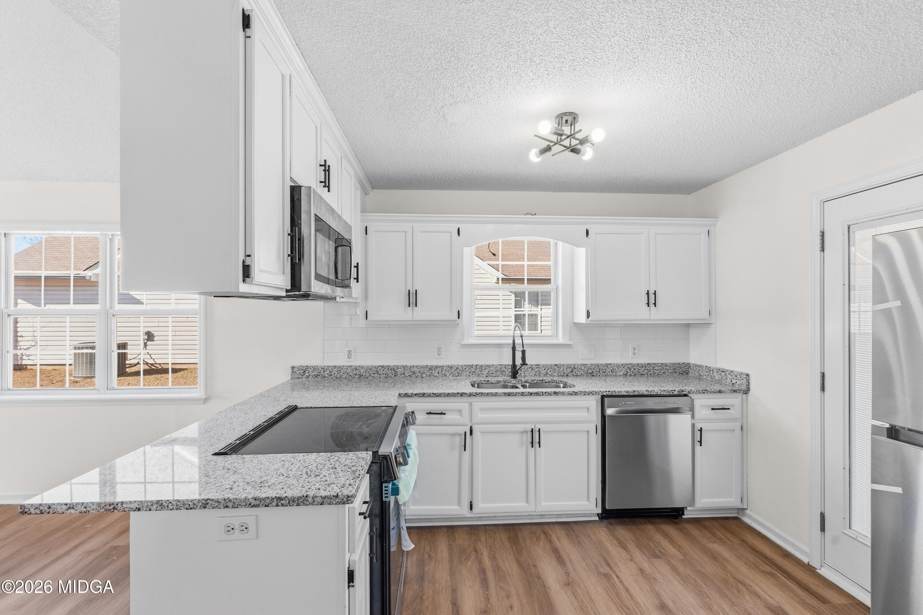 404 Wynfield Lane Bonaire, GA 31005 - Photo 13 of 45 a kitchen that has a sink a stove and cabinets