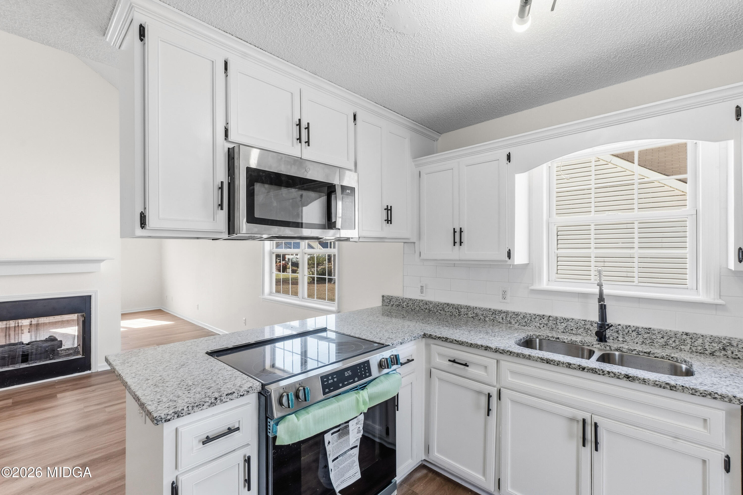 404 Wynfield Lane Bonaire, GA 31005 - Photo 14 of 45 a kitchen with granite countertop a sink stainless steel appliances and cabinets