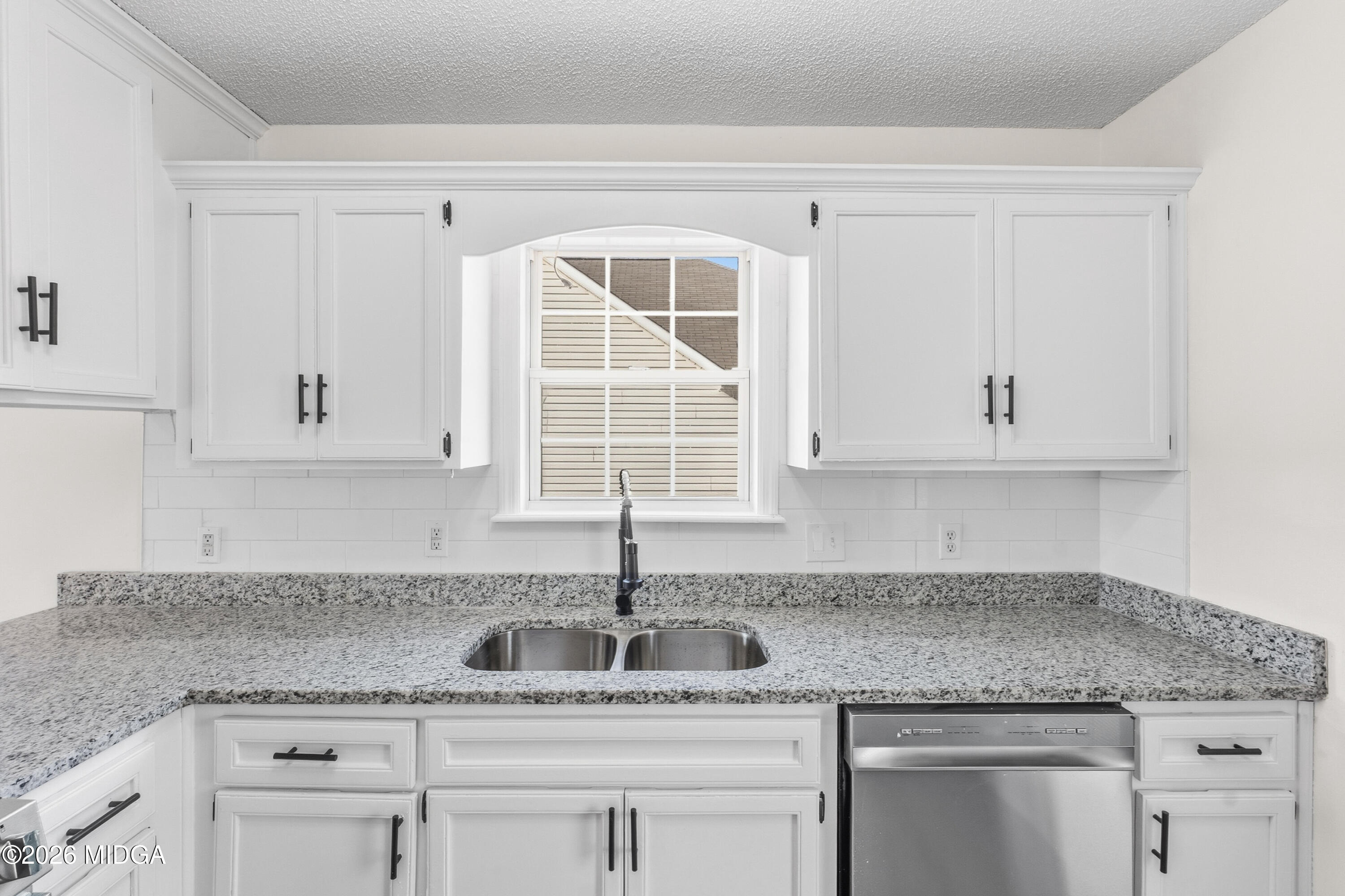 404 Wynfield Lane Bonaire, GA 31005 - Photo 15 of 45 a kitchen with granite countertop a sink cabinets and window