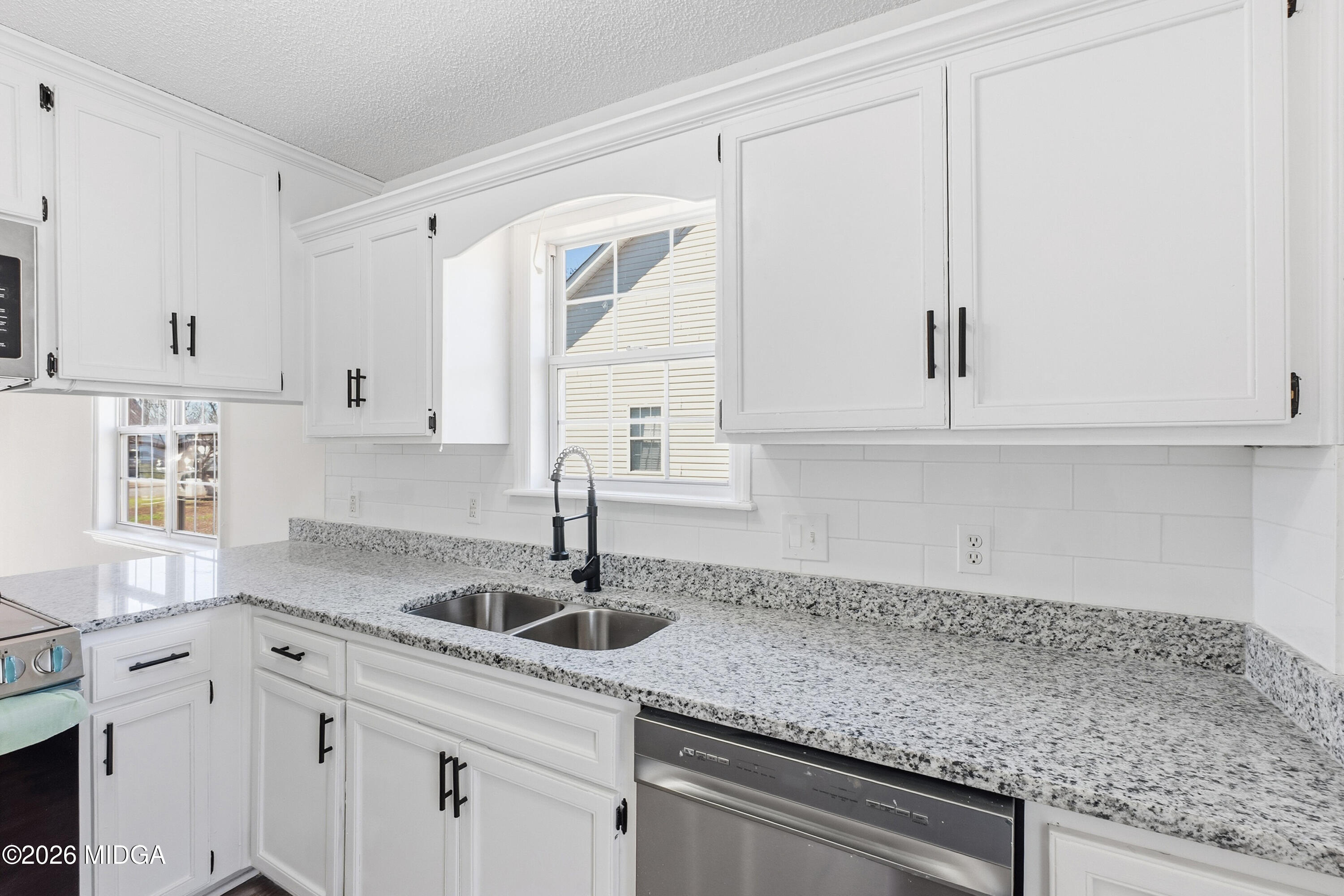 404 Wynfield Lane Bonaire, GA 31005 - Photo 16 of 45 a kitchen with granite countertop white cabinets and a sink