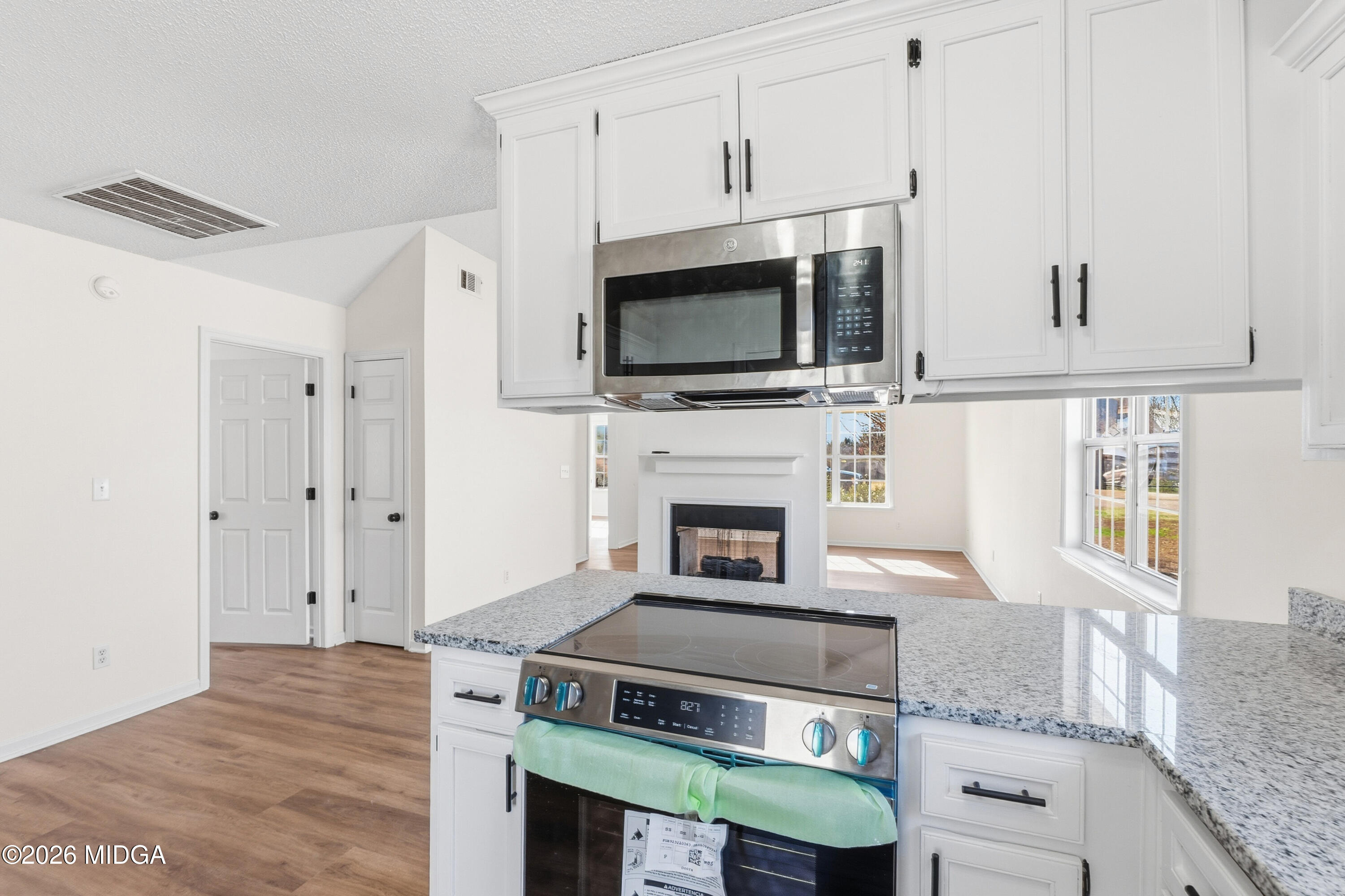 404 Wynfield Lane Bonaire, GA 31005 - Photo 17 of 45 a kitchen with stainless steel appliances granite countertop a stove and a microwave