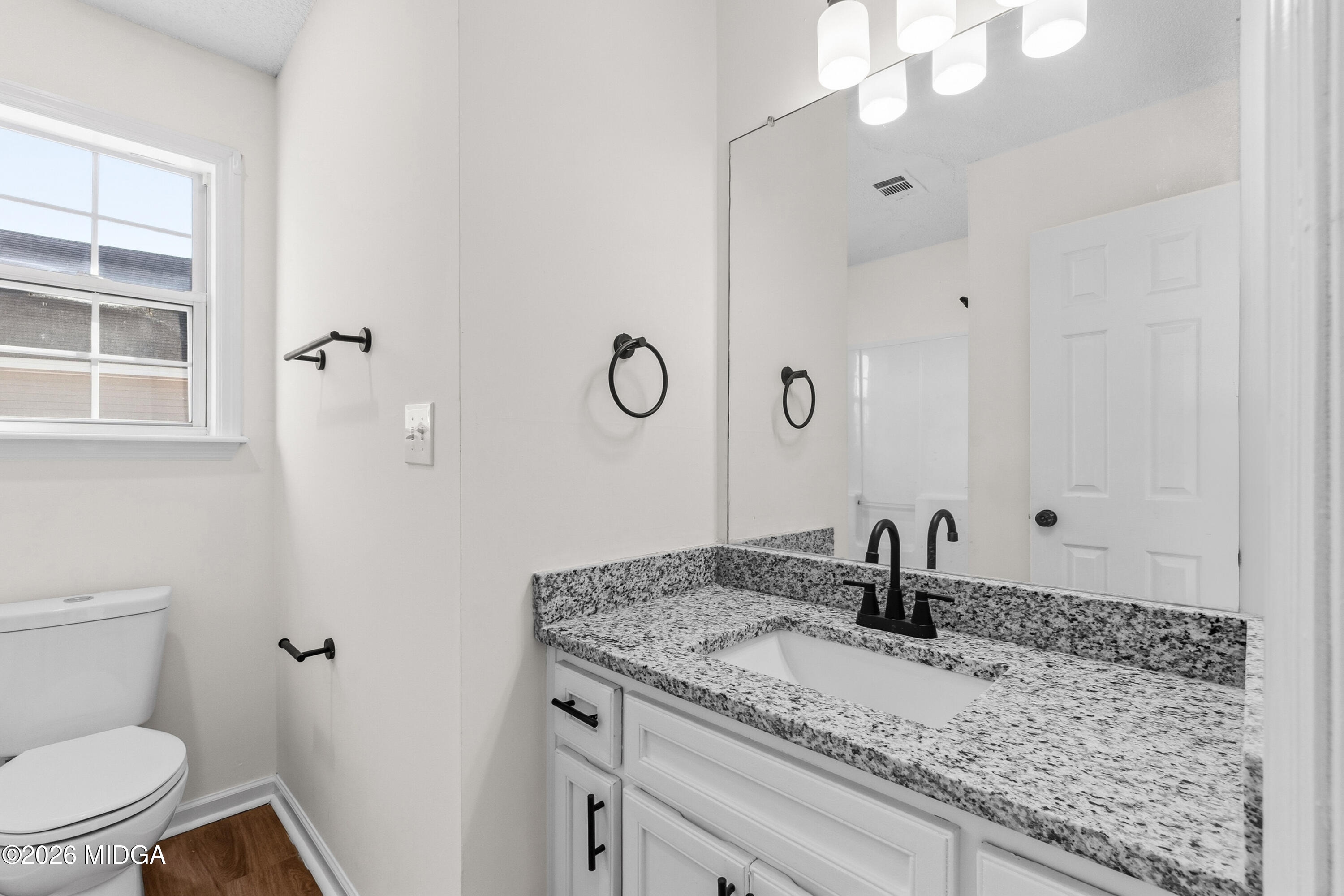 404 Wynfield Lane Bonaire, GA 31005 - Photo 21 of 45 a bathroom with a granite countertop sink a toilet and a mirror